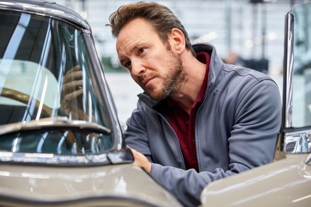 Mechaniker schraubt an einem Oldtimer